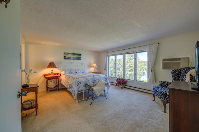 4 Goodridge Dr Unit 4, Naples, ME 04055 - bedroom featuring light carpet, a textured ceiling, a baseboard radiator, and a wall mounted AC