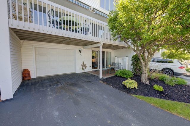 4 Goodridge Dr Unit 4, Naples, ME 04055 - view of property featuring a garage, a balcony, and asphalt driveway