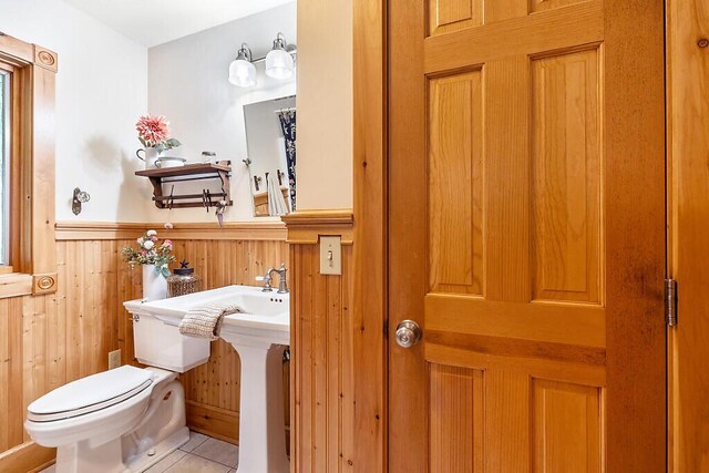 59 Lupine Dr, Belgrade, ME 04917 - half bath with toilet, wainscoting, wood walls, and tile patterned floors