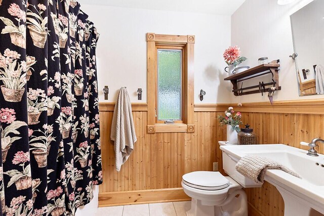 59 Lupine Dr, Belgrade, ME 04917 - bathroom with toilet, a wainscoted wall, tile patterned floors, wooden walls, and a shower with shower curtain