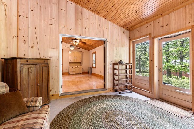 59 Lupine Dr, Belgrade, ME 04917 - entryway with vaulted ceiling, wooden walls, wooden ceiling, and baseboards