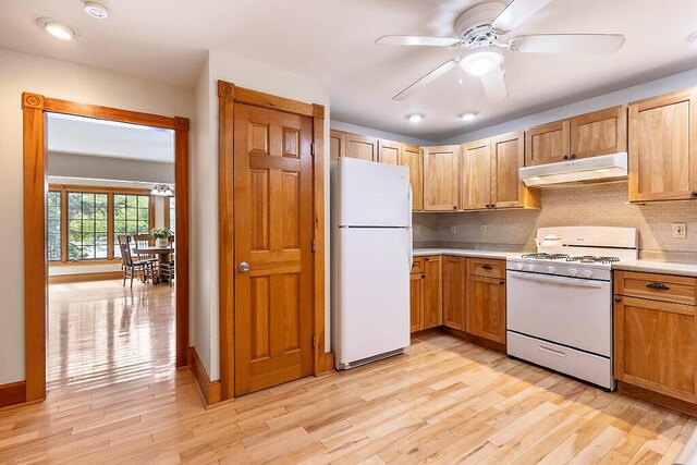 59 Lupine Dr, Belgrade, ME 04917 - kitchen with white appliances, under cabinet range hood, light countertops, and light wood-style floors
