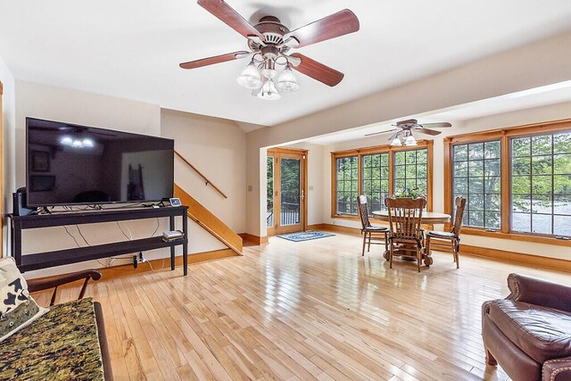 59 Lupine Dr, Belgrade, ME 04917 - dining room featuring baseboards, a ceiling fan, light wood-style flooring, and stairway