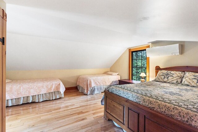 59 Lupine Dr, Belgrade, ME 04917 - bedroom with light wood-style floors and vaulted ceiling