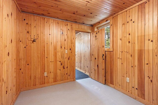 59 Lupine Dr, Belgrade, ME 04917 - carpeted empty room with wooden ceiling, wooden walls, and baseboards
