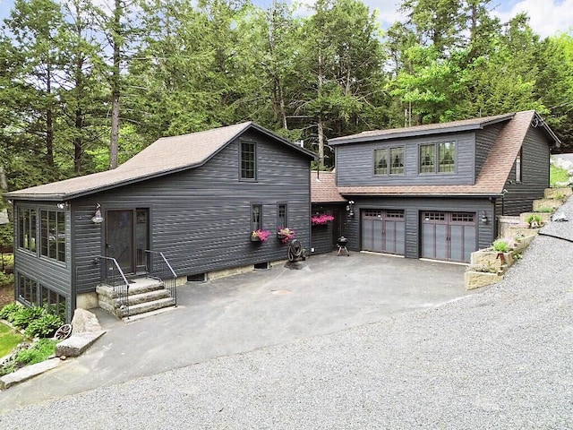 59 Lupine Dr, Belgrade, ME 04917 - view of front facade featuring asphalt driveway, an attached garage, and roof with shingles