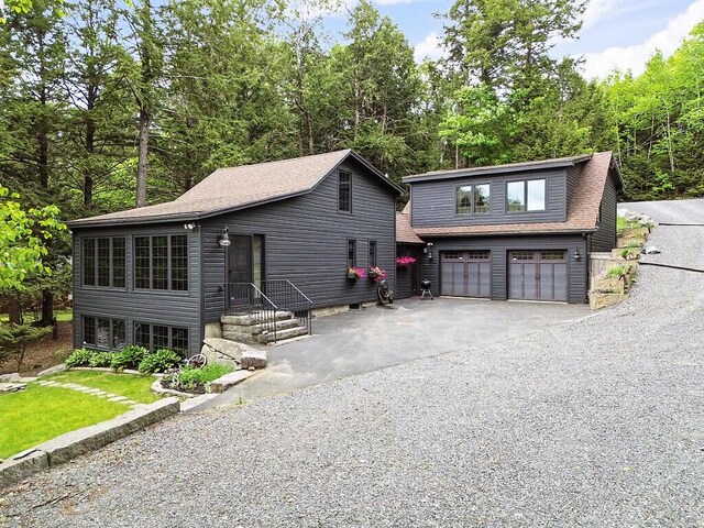 59 Lupine Dr, Belgrade, ME 04917 - view of front of property featuring asphalt driveway, an attached garage, and a shingled roof