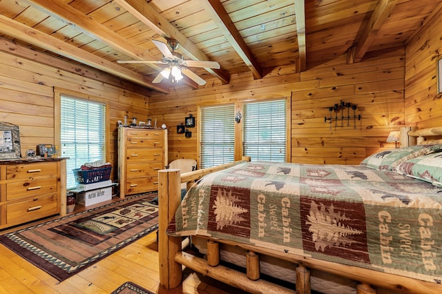 2451 Riverside Dr, Vassalboro, ME 04989 - bedroom featuring multiple windows, wood ceiling with exposed beams, wooden walls, and wood-type flooring