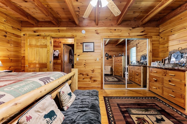2451 Riverside Dr, Vassalboro, ME 04989 - bedroom featuring wooden ceiling with exposed beams, light wood-style floors, and wood walls