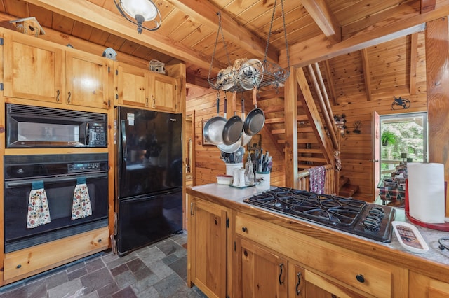 2451 Riverside Dr, Vassalboro, ME 04989 - kitchen with black appliances, wood ceiling with exposed beams, wood walls, dark stone finish flooring, and tile counters
