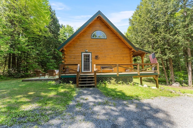 2451 Riverside Dr, Vassalboro, ME 04989 - view of front facade featuring log siding and a wooden deck