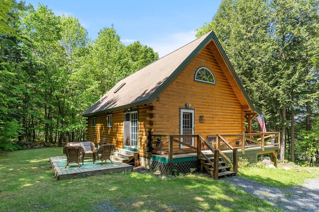 2451 Riverside Dr, Vassalboro, ME 04989 - rear view of house featuring log siding, a wooden deck, a yard, and an outdoor living space