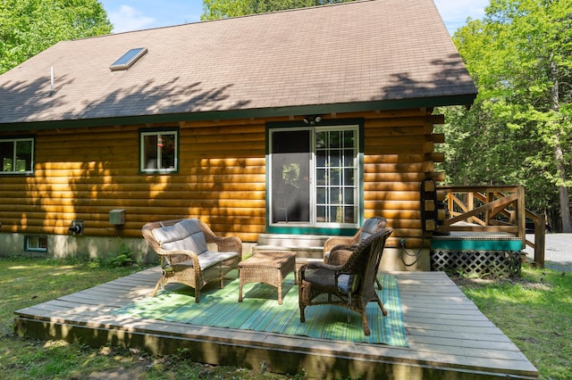 2451 Riverside Dr, Vassalboro, ME 04989 - back of property featuring a wooden deck, an outdoor hangout area, log siding, and roof with shingles