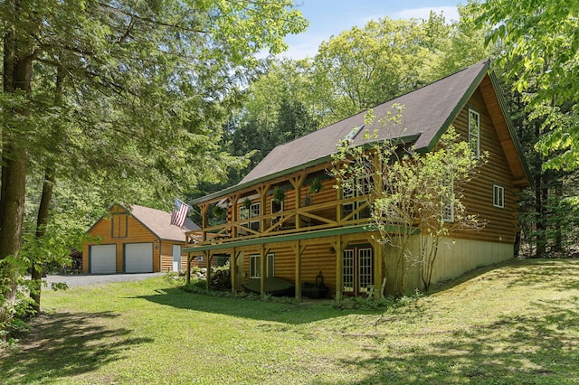 2451 Riverside Dr, Vassalboro, ME 04989 - rear view of property featuring an outbuilding, a lawn, a garage, a deck, and log exterior