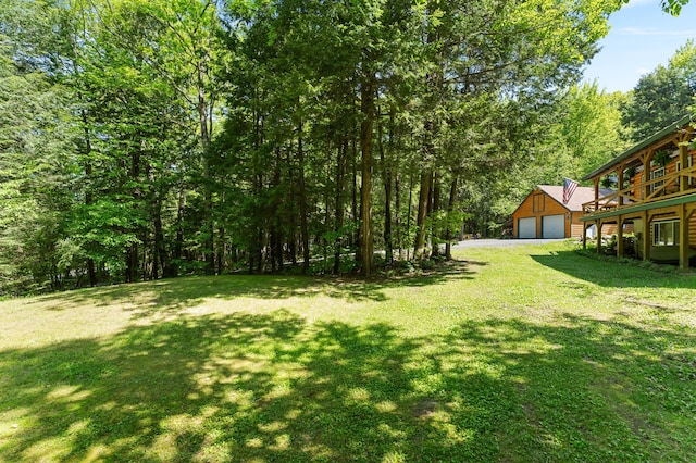 2451 Riverside Dr, Vassalboro, ME 04989 - view of grassy yard featuring a detached garage and an outbuilding