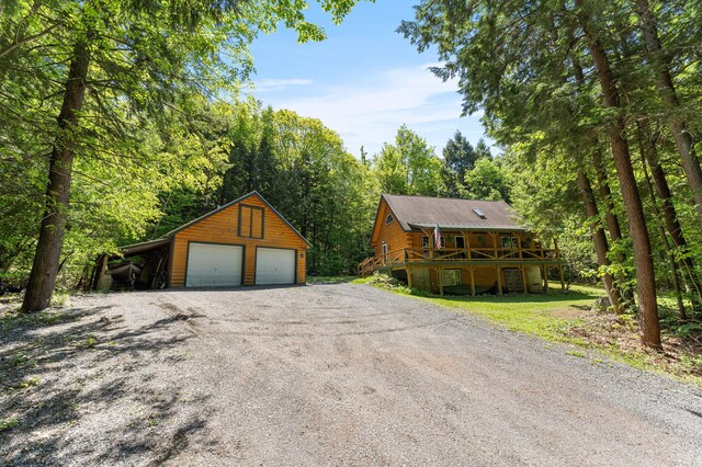 2451 Riverside Dr, Vassalboro, ME 04989 - view of front of property featuring a detached garage, an outdoor structure, a deck, and log exterior