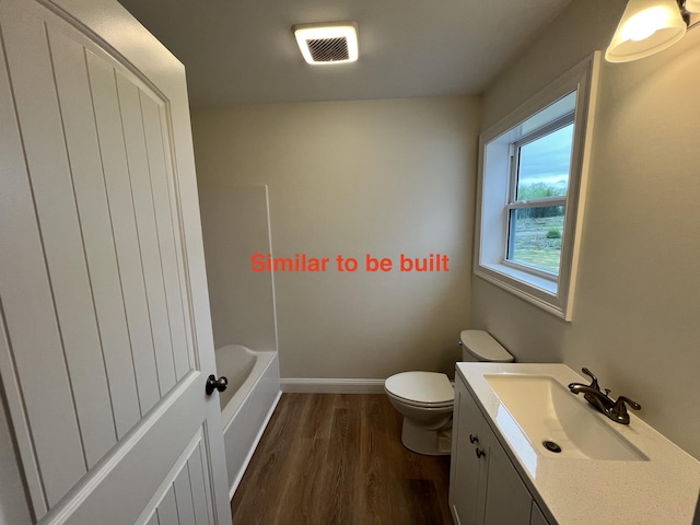 93 Union St, Orono, ME 04473 - full bath with toilet, wood finished floors, vanity, a tub to relax in, and baseboards