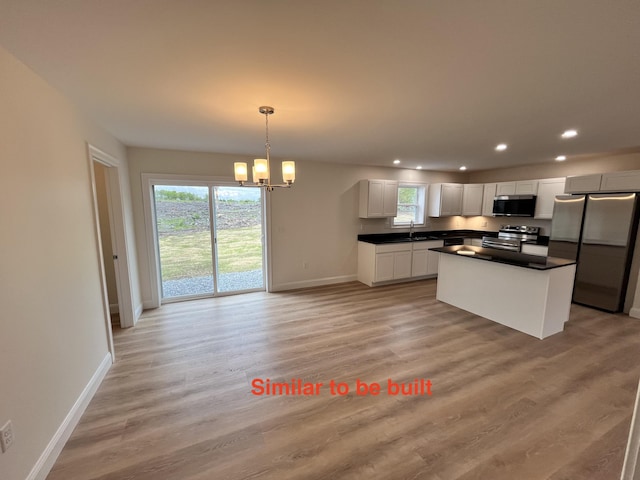 93 Union St, Orono, ME 04473 - kitchen featuring appliances with stainless steel finishes, a sink, recessed lighting, a chandelier, and baseboards