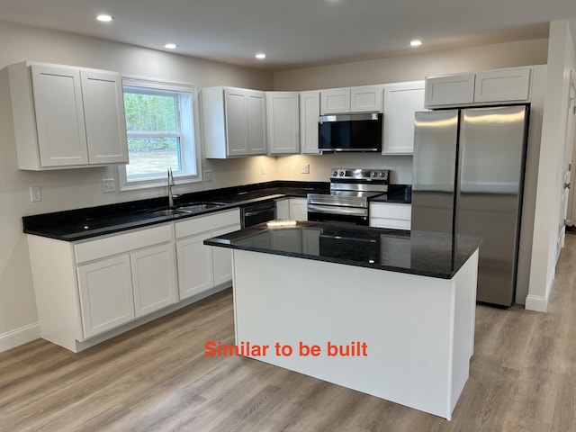 93 Union St, Orono, ME 04473 - kitchen with stainless steel appliances, a sink, light wood finished floors, a kitchen island, and recessed lighting