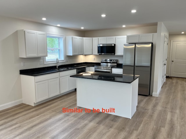 93 Union St, Orono, ME 04473 - kitchen with appliances with stainless steel finishes, a sink, a kitchen island, dark countertops, and recessed lighting