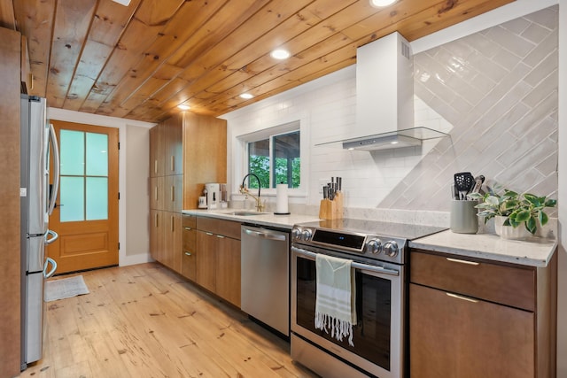 82 Harbor Rd, Naples, ME 04055 - kitchen featuring appliances with stainless steel finishes, wall chimney range hood, a sink, recessed lighting, and backsplash