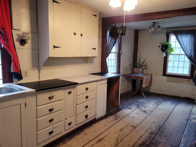 627 Waterville Rd, Skowhegan, ME 04976 - kitchen with wood-type flooring, white cabinets, and light countertops