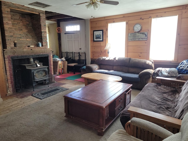 627 Waterville Rd, Skowhegan, ME 04976 - living area featuring a wood stove, ceiling fan, and wood finished floors