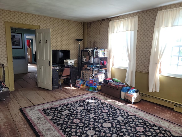 627 Waterville Rd, Skowhegan, ME 04976 - playroom with wallpapered walls, wood-type flooring, an office area, and baseboard heating