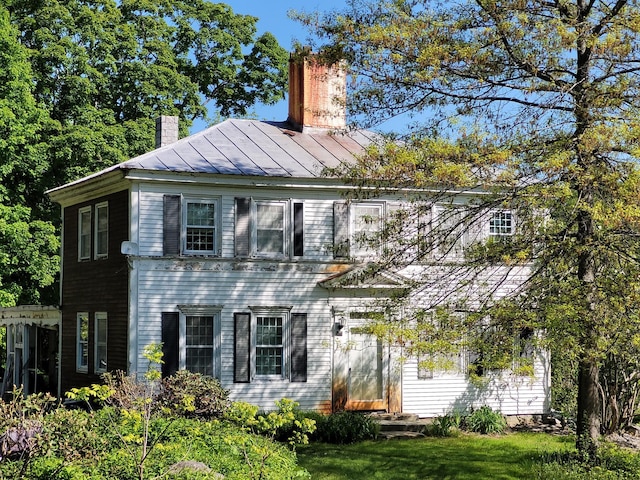 627 Waterville Rd, Skowhegan, ME 04976 - view of front of house with a standing seam roof, a chimney, and metal roof