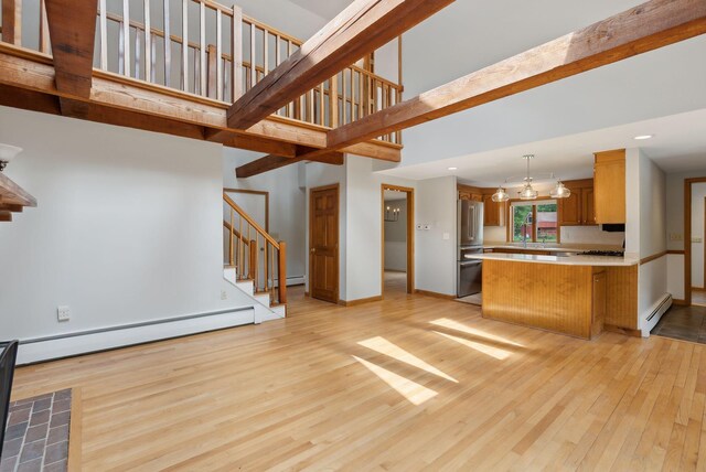 198 Range Rd, Cumberland, ME 04021 - unfurnished living room with a baseboard heating unit, light wood-style flooring, stairs, a high ceiling, and baseboards
