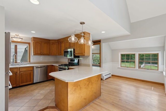 198 Range Rd, Cumberland, ME 04021 - kitchen featuring stainless steel appliances, a sink, light countertops, baseboard heating, and a peninsula