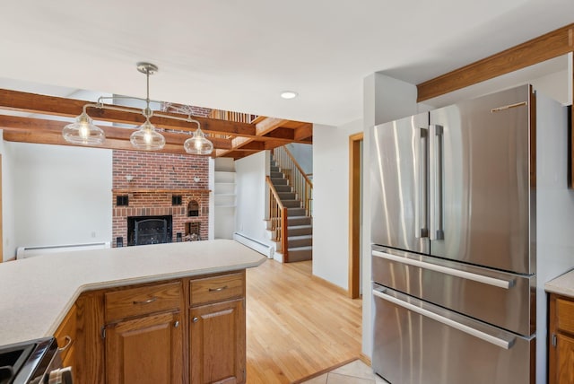 198 Range Rd, Cumberland, ME 04021 - kitchen featuring stainless steel appliances, a baseboard heating unit, light countertops, a fireplace, and beamed ceiling