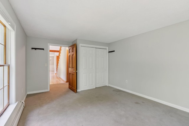 198 Range Rd, Cumberland, ME 04021 - unfurnished bedroom with baseboard heating, light colored carpet, baseboards, and a closet