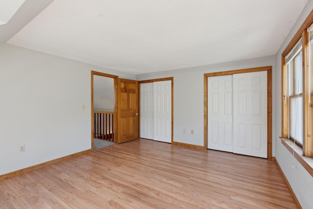 198 Range Rd, Cumberland, ME 04021 - unfurnished bedroom featuring two closets, light wood-style flooring, and baseboards