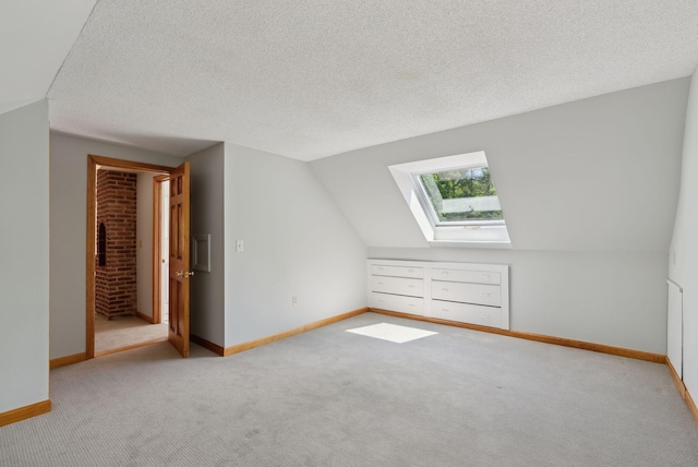 198 Range Rd, Cumberland, ME 04021 - additional living space with a skylight, carpet floors, baseboards, a textured ceiling, and lofted ceiling