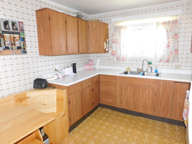 56 Allen St, Bangor, ME 04401 - kitchen with wallpapered walls, a sink, light countertops, and ornamental molding