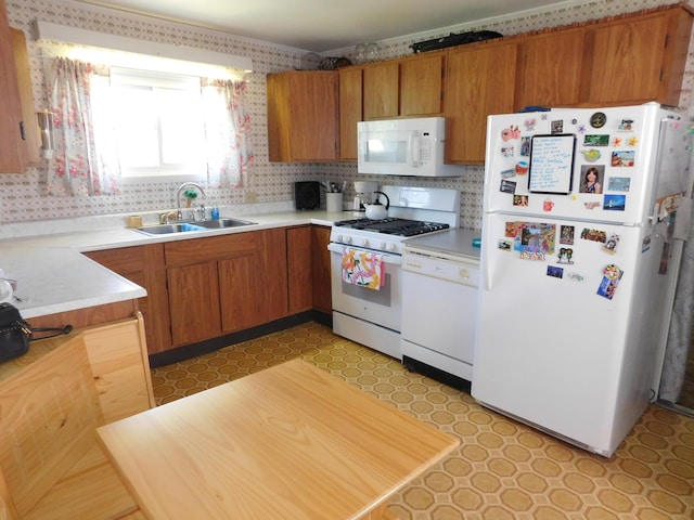 56 Allen St, Bangor, ME 04401 - kitchen featuring white appliances, a sink, light flooring, light countertops, and brown cabinetry