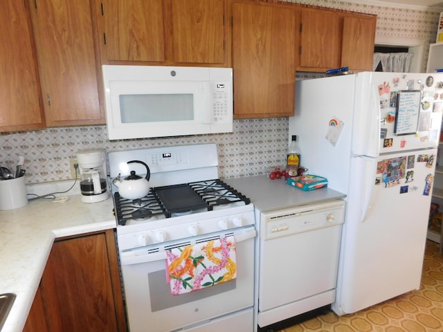 56 Allen St, Bangor, ME 04401 - kitchen featuring white appliances, light countertops, backsplash, and brown cabinets