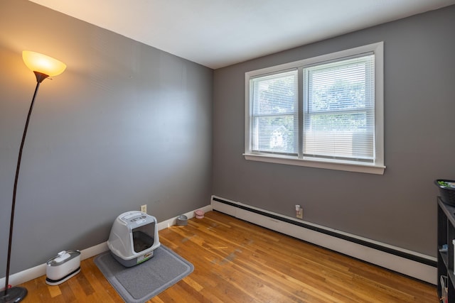 4 Scribner Cir, Lewiston, ME 04240 - empty room with a baseboard radiator and light wood-type flooring