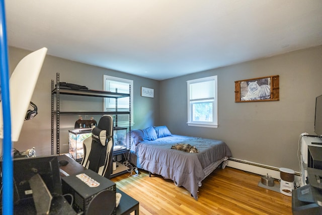 4 Scribner Cir, Lewiston, ME 04240 - bedroom featuring multiple windows, wood finished floors, and a baseboard radiator