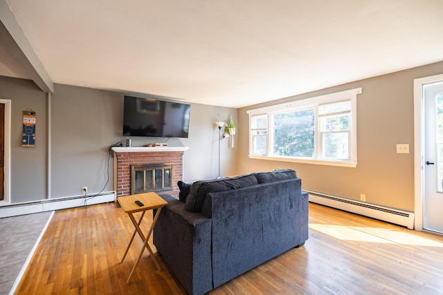 4 Scribner Cir, Lewiston, ME 04240 - living room featuring a baseboard radiator, wood-type flooring, and a brick fireplace