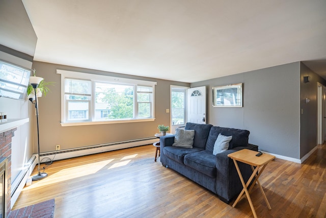4 Scribner Cir, Lewiston, ME 04240 - living area with a fireplace, wood finished floors, and a baseboard heating unit