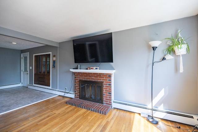 4 Scribner Cir, Lewiston, ME 04240 - unfurnished living room with a baseboard radiator, a fireplace, and wood finished floors
