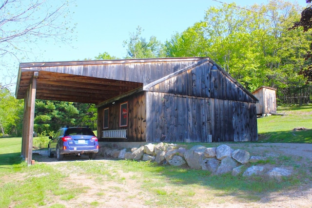 35 Harmon Notch Rd, Brownfield, ME 04010 - view of front facade with an outdoor structure, dirt driveway, a front yard, and an attached carport