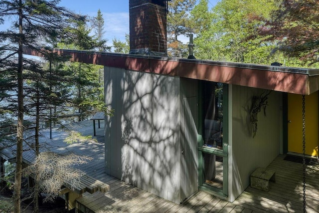 93 Eaton Point Rd, Deer Isle, ME 04627 - view of side of home with a chimney and a wooden deck