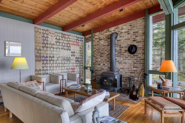 93 Eaton Point Rd, Deer Isle, ME 04627 - living room featuring a wood stove, wood finished floors, and wooden ceiling with exposed beams