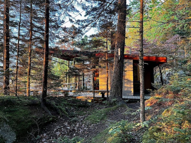 93 Eaton Point Rd, Deer Isle, ME 04627 - view of side of home featuring an outdoor structure and a forest view