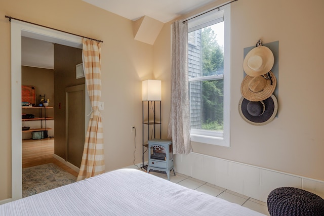 38 Johnson Cove Rd, Otis, ME 04605 - bedroom with a wood stove and tile patterned flooring