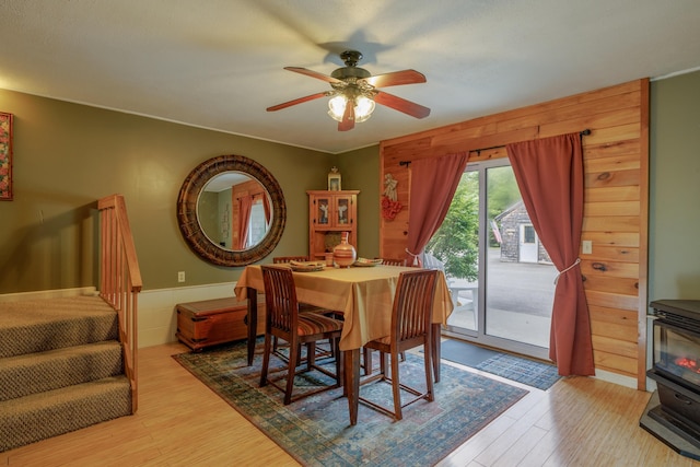 38 Johnson Cove Rd, Otis, ME 04605 - dining room featuring wood finished floors, a wood stove, and ceiling fan