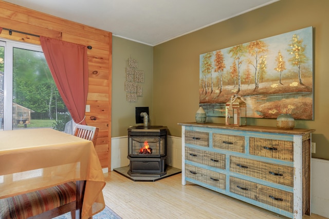 38 Johnson Cove Rd, Otis, ME 04605 - bedroom with a wood stove, wood finished floors, and crown molding